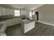 Open kitchen with white cabinets, granite countertops, and an island at 129 Grace Pond Ave, Benson, NC 27504