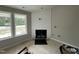 Cozy living room with a shiplap fireplace, large windows, and natural light at 129 Grace Pond Ave, Benson, NC 27504