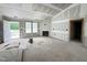 Open-concept living room features a fireplace, recessed lighting, and a doorway view into the backyard at 129 Grace Pond Ave, Benson, NC 27504