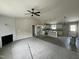 Open-concept living room and kitchen with a fireplace and hardwood floors at 129 Grace Pond Ave, Benson, NC 27504
