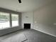 Bright living room featuring a modern fireplace and large windows for natural light at 129 Grace Pond Ave, Benson, NC 27504