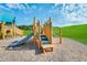 Community playground featuring slides, climbing structures and platforms on wood chip ground and green space at 1300 Hazelnut Ridge Ln, Knightdale, NC 27545