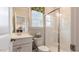 Well-lit bathroom showcasing a vanity, toilet, and a modern glass-enclosed shower at 1304 Hazelnut Ridge Ln, Knightdale, NC 27545