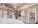 Well-lit main bedroom boasting a decorative ceiling, ensuite bathroom, and neutral decor at 1304 Hazelnut Ridge Ln, Knightdale, NC 27545