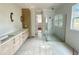 Bathroom with walk-in shower, double vanity, wood cabinets, and tile flooring at 1309 Sanctuary Pond Dr, Raleigh, NC 27603
