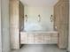 Bathroom featuring a double vanity, quartz countertops, wood cabinets, and modern lighting at 1309 Sanctuary Pond Dr, Raleigh, NC 27603