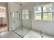 Bathroom showcasing a glass enclosed shower with a rain shower head and white tile walls at 1309 Sanctuary Pond Dr, Raleigh, NC 27603