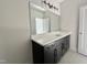 Bathroom includes modern vanity with sleek dark wood cabinets and a stone countertop at 1309 Sanctuary Pond Dr, Raleigh, NC 27603