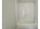 Bathroom bathtub and shower combination with clean white tiling in neutral room at 1309 Sanctuary Pond Dr, Raleigh, NC 27603