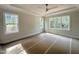 Bedroom with tray ceiling, neutral paint, ceiling fan, and many windows for natural light at 1309 Sanctuary Pond Dr, Raleigh, NC 27603