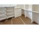 Walk-in closet with white shelving and drawers for ample storage space at 1309 Sanctuary Pond Dr, Raleigh, NC 27603