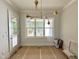 Sun-filled dining area with a modern chandelier fixture and direct access to the backyard at 1309 Sanctuary Pond Dr, Raleigh, NC 27603
