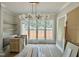 Bright dining room featuring a modern light fixture, large windows, and built-in cabinetry at 1309 Sanctuary Pond Dr, Raleigh, NC 27603