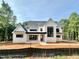 Stunning new construction home with modern black trim, board and batten siding, and a metal roof at 1309 Sanctuary Pond Dr, Raleigh, NC 27603