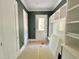 Mudroom featuring coat hooks, storage and bench with direct access to the exterior at 1309 Sanctuary Pond Dr, Raleigh, NC 27603