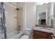 This tiled bathroom features a shower-tub combo, granite vanity, and neutral decor at 150 Lystra Ridge Rd, Chapel Hill, NC 27517