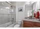 Tiled bathroom features a shower-tub, vanity with granite countertop, and neutral decor at 150 Lystra Ridge Rd, Chapel Hill, NC 27517