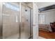 Modern glass shower in renovated bathroom with bright natural light from window at 150 Lystra Ridge Rd, Chapel Hill, NC 27517
