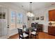 Bright dining room with large windows offering natural light and views of the outdoors at 150 Lystra Ridge Rd, Chapel Hill, NC 27517