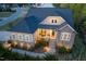 Inviting two-story home featuring stone accents, a cozy porch, and manicured landscaping at 150 Lystra Ridge Rd, Chapel Hill, NC 27517