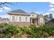 Charming home featuring a combination of stone and siding, well-manicured landscaping, and welcoming entryway at 150 Lystra Ridge Rd, Chapel Hill, NC 27517