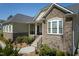 Eye-catching stone and siding combo with a delightful front porch and manicured shrubbery at 150 Lystra Ridge Rd, Chapel Hill, NC 27517
