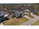 Exterior showcasing a home with a well-manicured lawn, patio, and tree-lined surroundings at 150 Lystra Ridge Rd, Chapel Hill, NC 27517