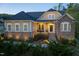 Stylish two-story home showcasing stone and siding, enhanced by landscape lighting at 150 Lystra Ridge Rd, Chapel Hill, NC 27517