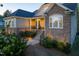 Charming exterior showcasing stone and siding, well-lit stairs leading to a welcoming porch, and landscaped details at 150 Lystra Ridge Rd, Chapel Hill, NC 27517