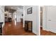 Hallway view showcasing hardwood floors, neutral walls, doorways, and a decorative console table at 150 Lystra Ridge Rd, Chapel Hill, NC 27517
