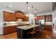 Well-equipped kitchen with granite countertops, a central island, and modern stainless steel appliances at 150 Lystra Ridge Rd, Chapel Hill, NC 27517