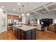 Open-concept kitchen with granite island, stainless appliances, and an eat-in area at 150 Lystra Ridge Rd, Chapel Hill, NC 27517