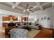 Spacious living area with coffered ceilings flowing seamlessly into a kitchen area with an island and seating at 150 Lystra Ridge Rd, Chapel Hill, NC 27517