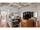 Open-concept living room features coffered ceilings, wood floors, and a comfortable seating arrangement at 150 Lystra Ridge Rd, Chapel Hill, NC 27517