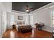 Relaxing bedroom boasts tray ceiling, hardwood floors, and ample natural light at 150 Lystra Ridge Rd, Chapel Hill, NC 27517