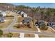 Residential street featuring well-maintained homes, mature trees, and neat landscaping at 150 Lystra Ridge Rd, Chapel Hill, NC 27517