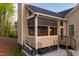 Inviting screened porch with stairs to patio, perfect for enjoying peaceful outdoor living at 150 Lystra Ridge Rd, Chapel Hill, NC 27517