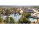Scenic aerial view of a community, showcasing a serene lake and a sparkling blue swimming pool at 154 Alamosa Pl, Cary, NC 27519