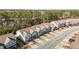 A picturesque street lined with modern townhomes, each boasting private driveways and manicured front yards at 154 Alamosa Pl, Cary, NC 27519