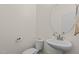 Stylish half bathroom features a modern sink and round mirror at 154 Alamosa Pl, Cary, NC 27519