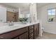 Bathroom features a double vanity, warm wood cabinets, and a tiled shower at 154 Alamosa Pl, Cary, NC 27519