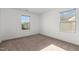 Bright bedroom features plush carpet, neutral walls, and dual windows for natural light at 154 Alamosa Pl, Cary, NC 27519
