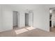 Spacious bedroom features plush carpet, neutral walls, and multiple doorways at 154 Alamosa Pl, Cary, NC 27519