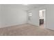 Sunlit bedroom featuring plush carpeting and an adjacent ensuite bathroom at 154 Alamosa Pl, Cary, NC 27519