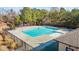 A sparkling community pool with clear blue water, surrounded by a secure fence and ample deck space at 154 Alamosa Pl, Cary, NC 27519