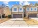 Two-story townhome with a brick and siding facade, two-car garage, and concrete driveway at 154 Alamosa Pl, Cary, NC 27519