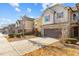 Well-maintained townhomes feature brick accents, a driveway, and manicured landscaping at 154 Alamosa Pl, Cary, NC 27519