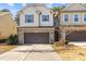 Charming townhome with a brick and siding exterior, two-car garage, and well-maintained landscaping at 154 Alamosa Pl, Cary, NC 27519