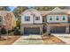 Charming townhomes with brick accents, brown shutters, and well-manicured landscaping at 154 Alamosa Pl, Cary, NC 27519