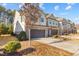 Beautiful townhome exteriors featuring brick accents and driveways, providing great curb appeal at 154 Alamosa Pl, Cary, NC 27519